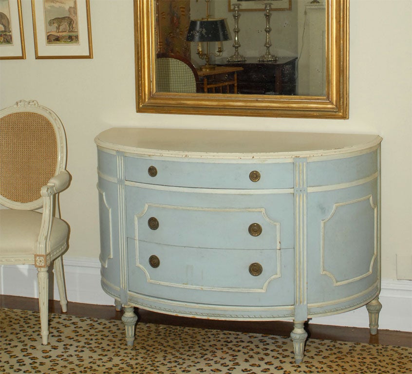A three-drawer painted demilune commode/buffet in the Directoire style.